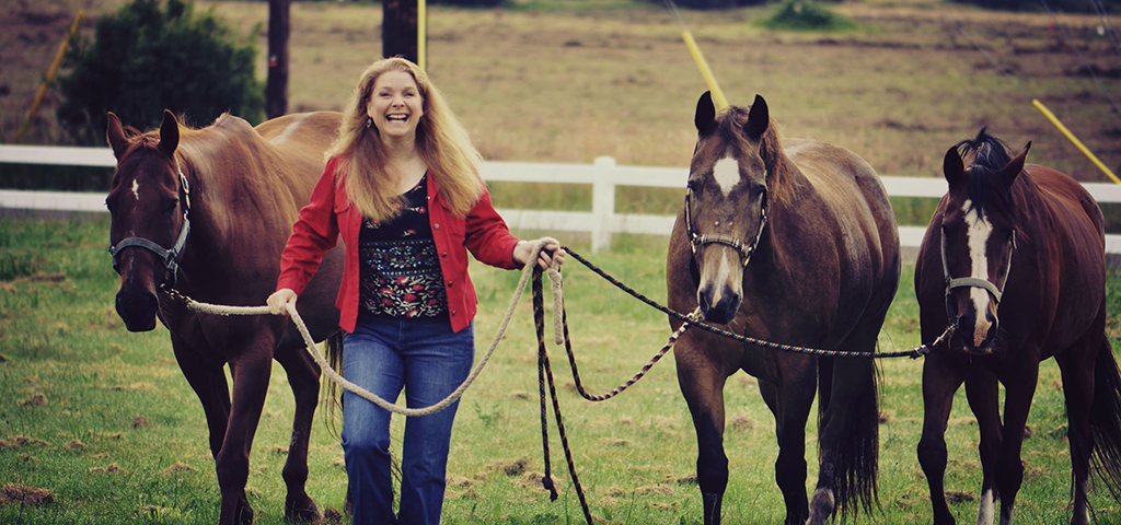 Kellie Grill leading horses to a Ranch Retreat